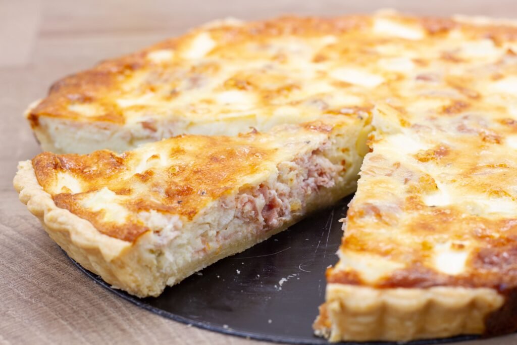 Tart with white asparagus, prosciutto and cheese on shortcrust pastry