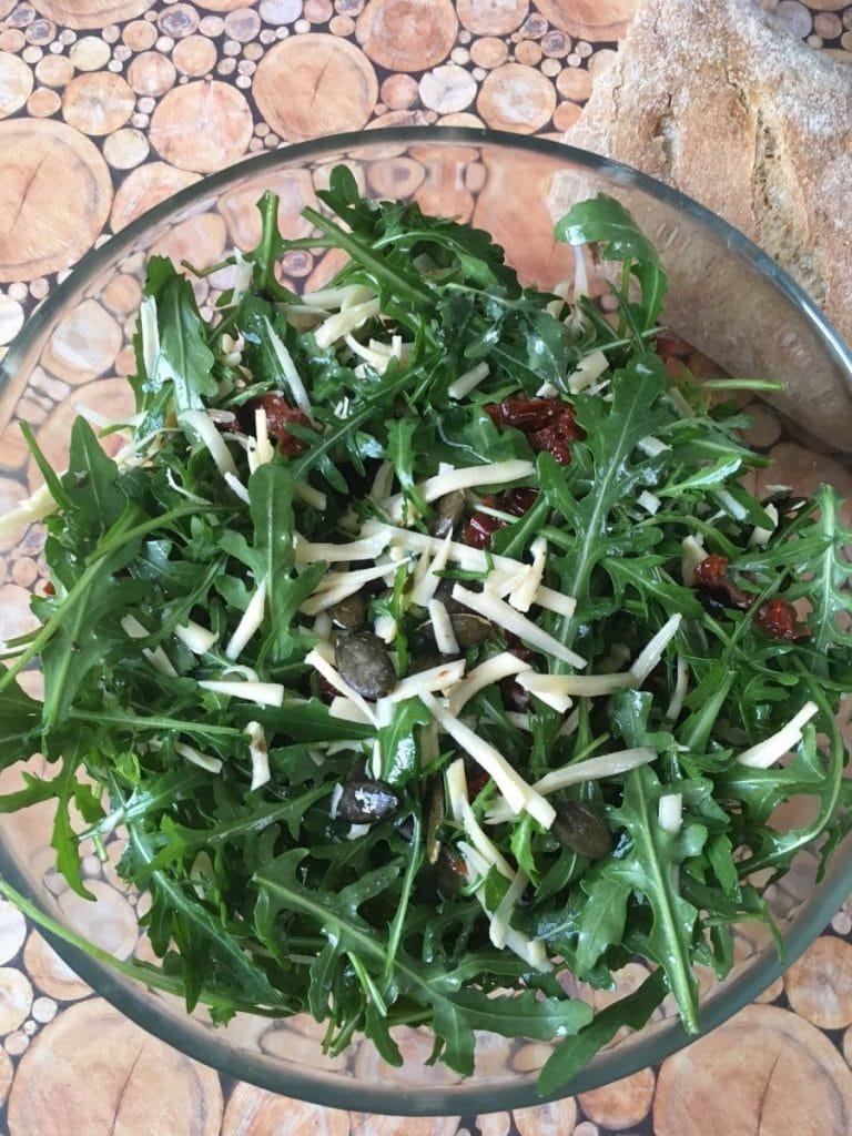 Arugula, cheese and sun-dried tomatoes salad